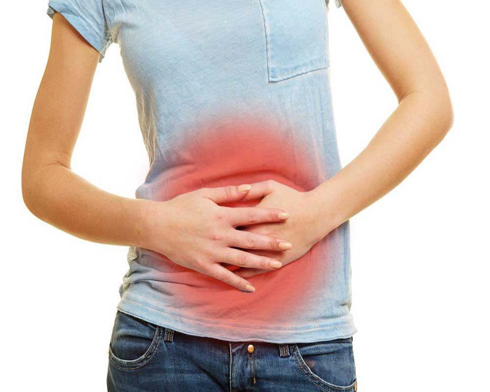 woman hands on tummy due to leaky gut pain