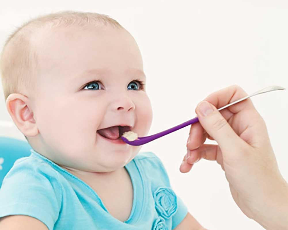 baby smiling while eating